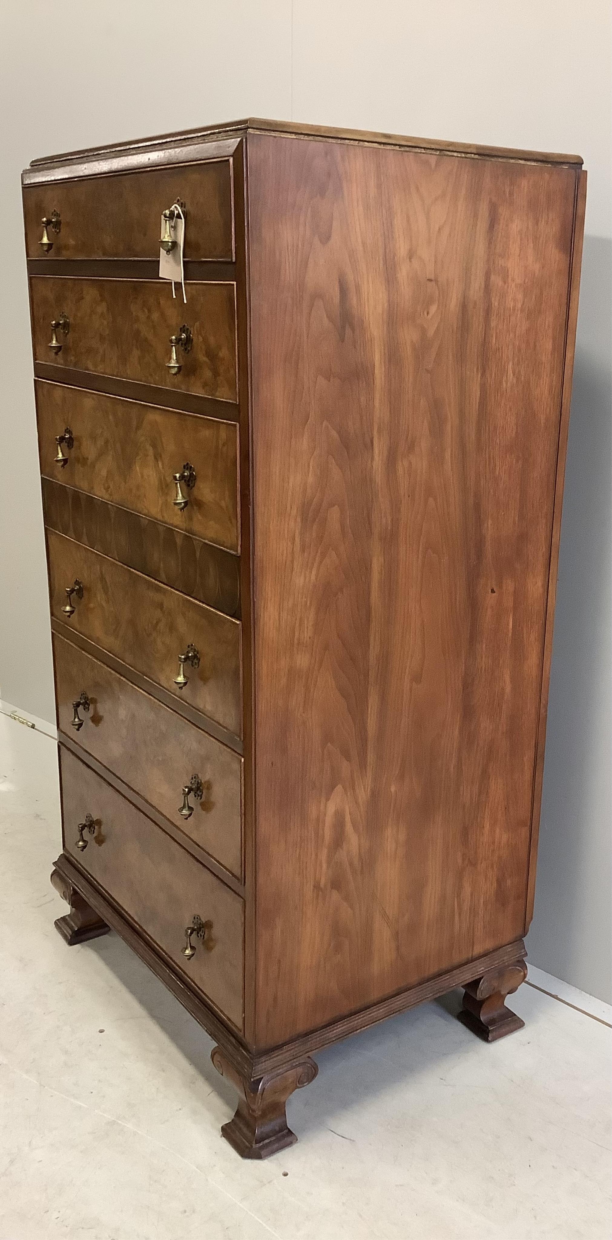 A Queen Anne Revival figured walnut and laburnam oyster veneered six drawer tall chest, width 70cm, depth 53cm, height 134cm. Condition - good